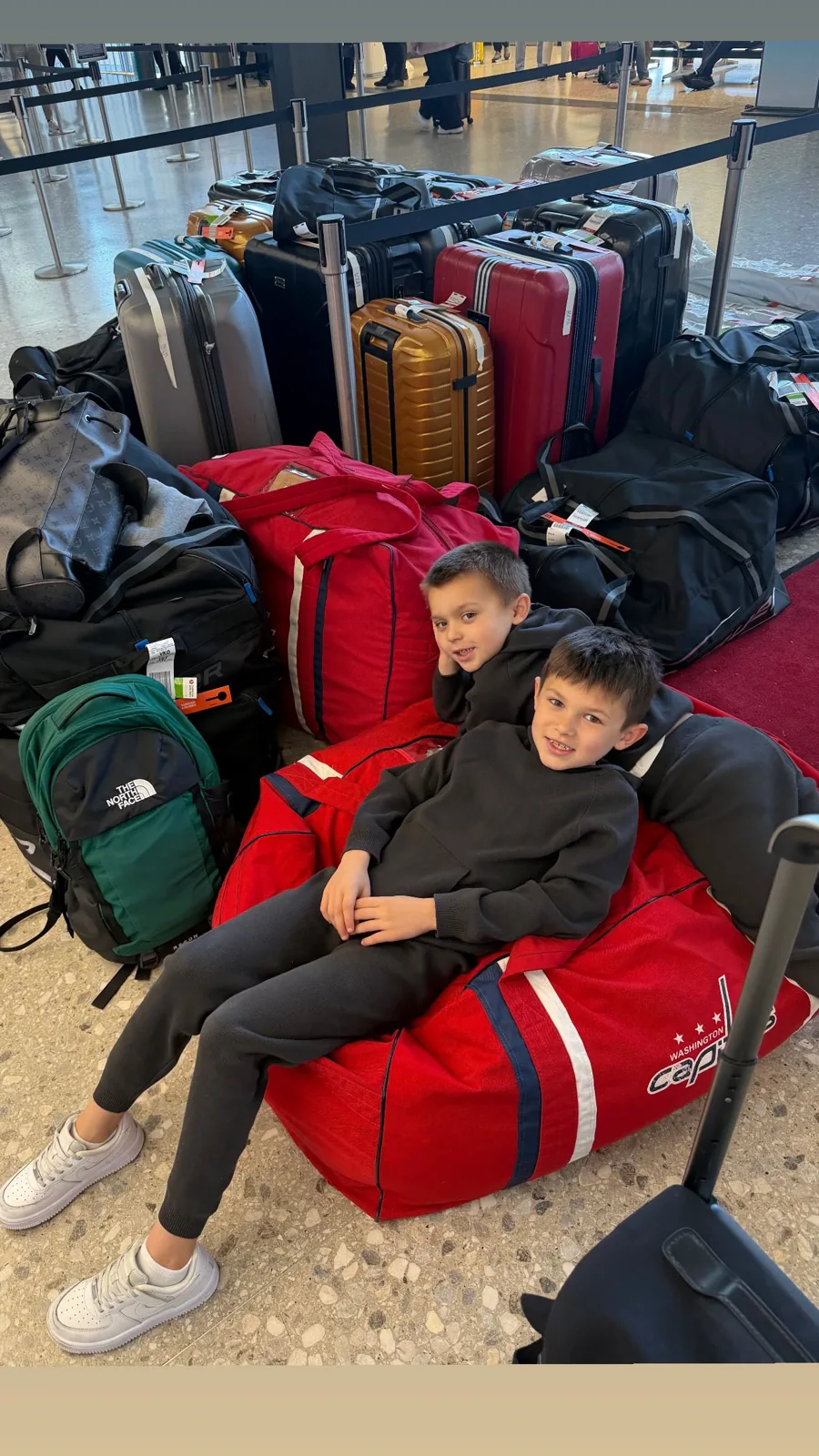 Sergei and Ilya Ovechkin perched on the family's luggage