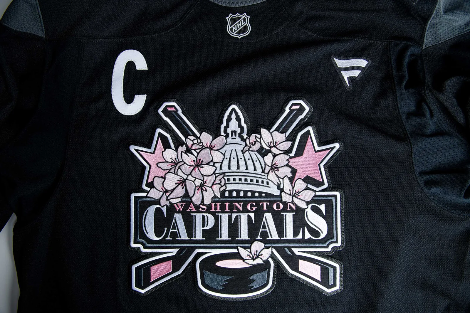 A tight shot of the Capitals crest beside the captain's 'C'